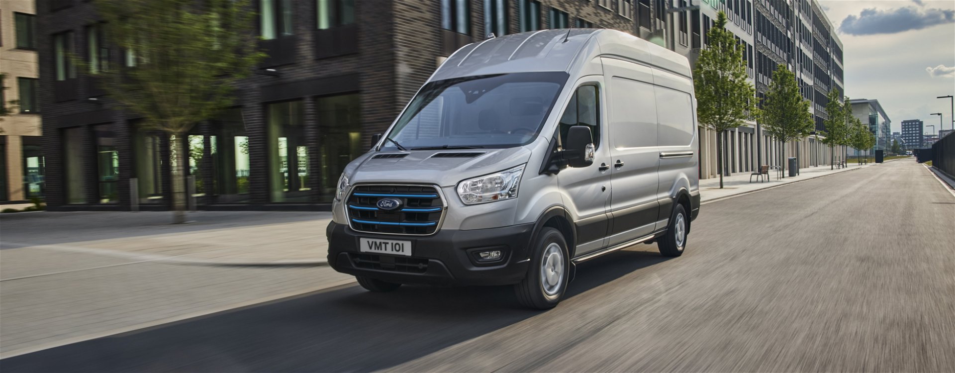 Grey Ford E-Transit electric van driving down the road
